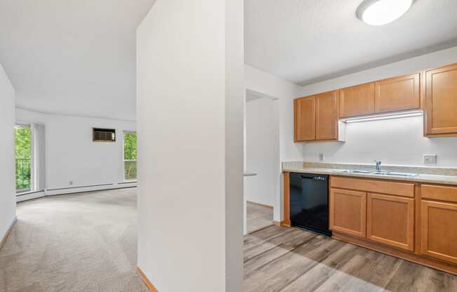 a kitchen and living room with wood flooring and white walls