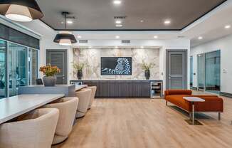 a living room with chairs and a table and a television
