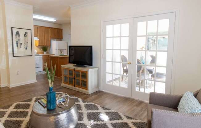 A living room with a television, a sofa, and a coffee table.