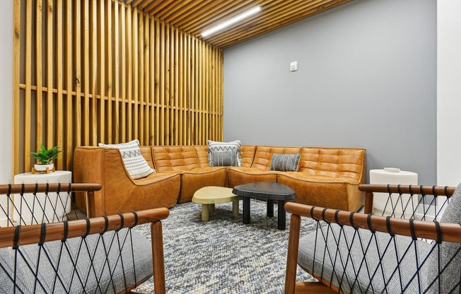 a living room with a couch and tables at Link Apartments® Calyx, North Carolina