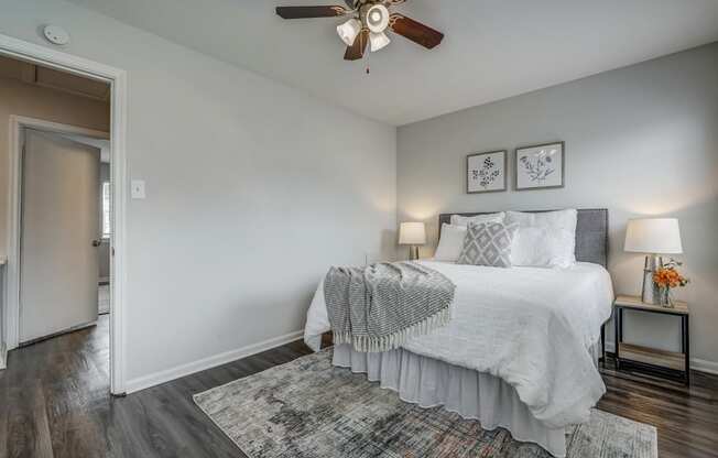 a bedroom with a bed and a ceiling fan
