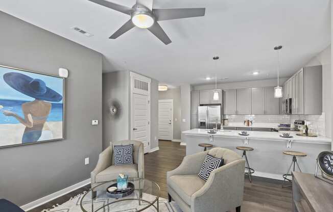 an open living room and kitchen with a ceiling fan
