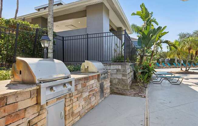 A modern house with a black fence and a brick wall.