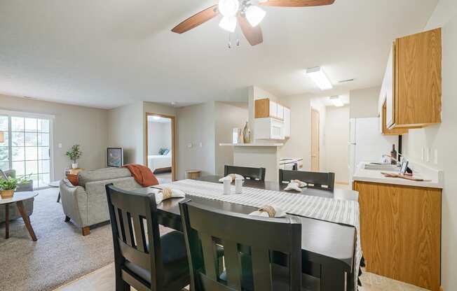 the view of the living room and dining room with table and chairs