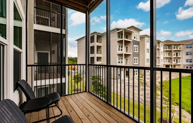 a screened in balcony with a wood floor
