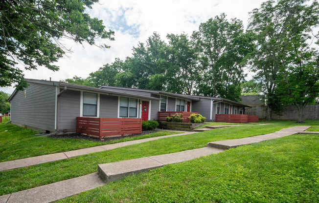 A row of apartments at The Retreat at Indian Lake studio and 1 bedroom apartments in Hendersonville with green grass in front.