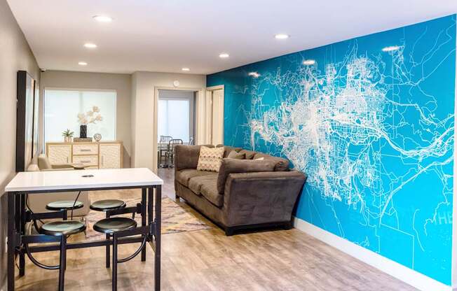 a lounge room with a blue wall with a couch and a table