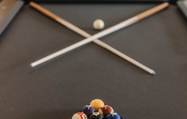 a pool table with billiard balls and sticks at 44 West Luxury Living, Missouri, 63088