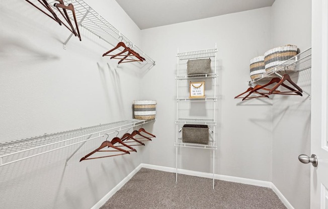 Walk-in closet with ample storage space at The Grand at Upper Kirby apartments in Houston, TX