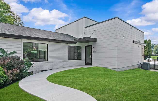 A modern building with a grey exterior and a black roof.