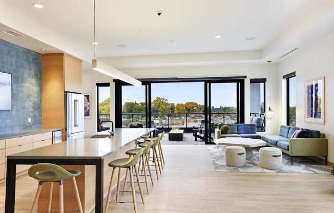 A modern kitchen with a long table and chairs.