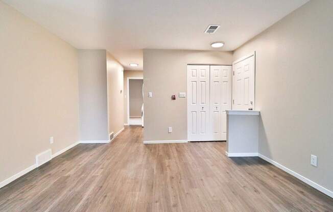A room with wood flooring and white walls.