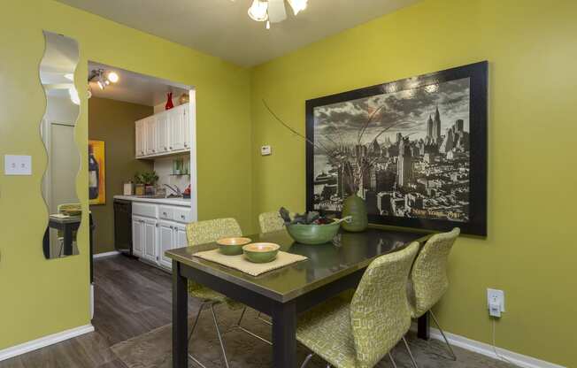 a dining room with a table and chairs and a painting on the wall at Village Club of Rochester Hills, Michigan, 48317