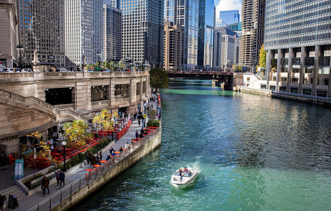 a boat is going down a river in a city
