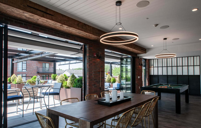 a dining room with a table and chairs and a pool table