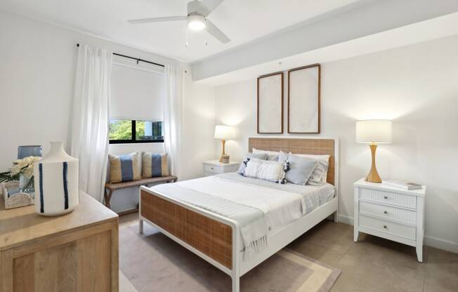 Bedroom 1 in B1 Floor Plan with large bed and nightstand at Westgate on University in Lauderhill, FL