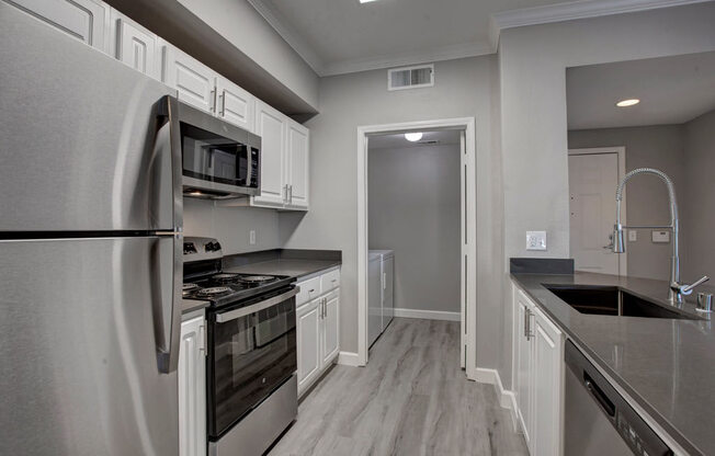 a kitchen with a stove top oven next to a refrigerator