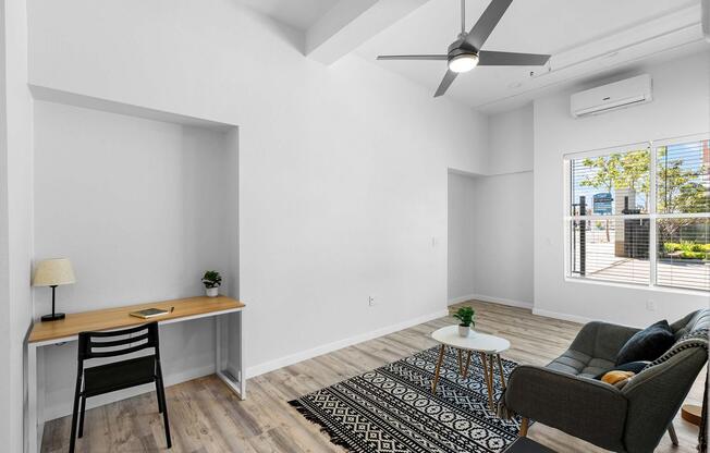 a living room filled with furniture and a large window