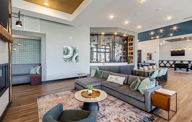 A modern living room with a grey sofa and a wooden coffee table.