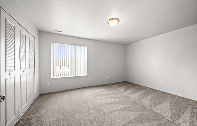 Spacious bedroom with ample storage space at Knottingham Apartments in Clinton Township, MI.