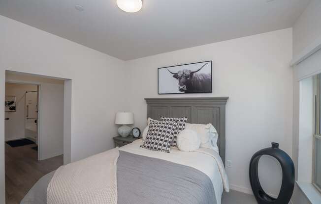 a bedroom with a bed and a picture of a bull at The Crossings at Windsong, Arizona, 86314
