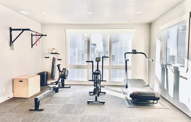 a home gym with weights and a window