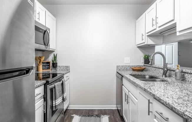 a kitchen with granite counter tops and stainless steel appliances