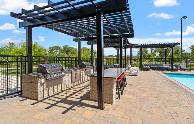 grilling stations in the outdoor pool area at TRIO @ Southbridge apartments