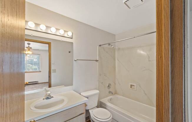 a bathroom with a sink and a tub and a shower