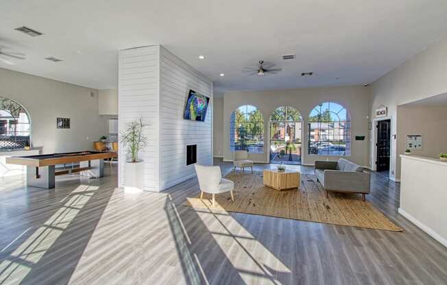 a spacious living room with a pool table and a flat screen tv