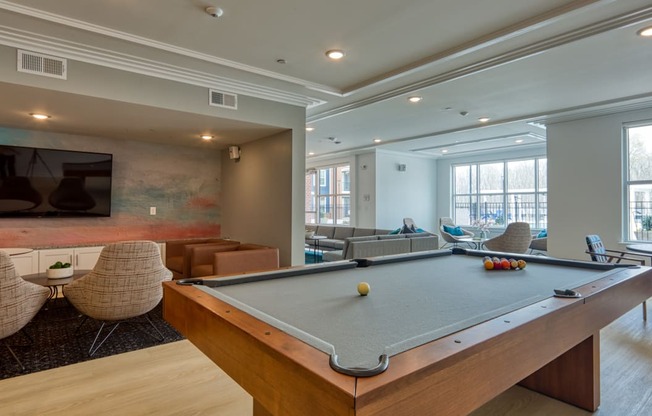 a community room with a pool table and a tv at The Bella at Westchester, Midlothian, VA