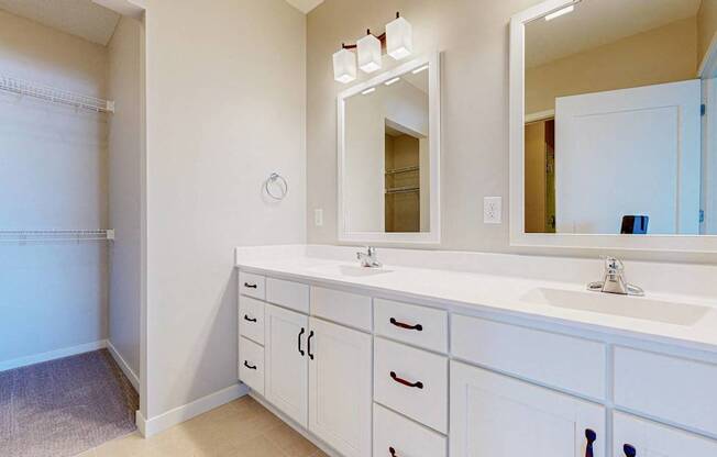 A bathroom with a sink, mirror, and cabinets.