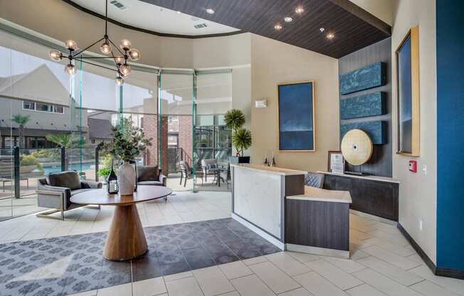 Leasing office with view of resort-style pool, grilling station, and fitness center