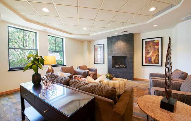 A living room with a fireplace, a couch, and chairs.