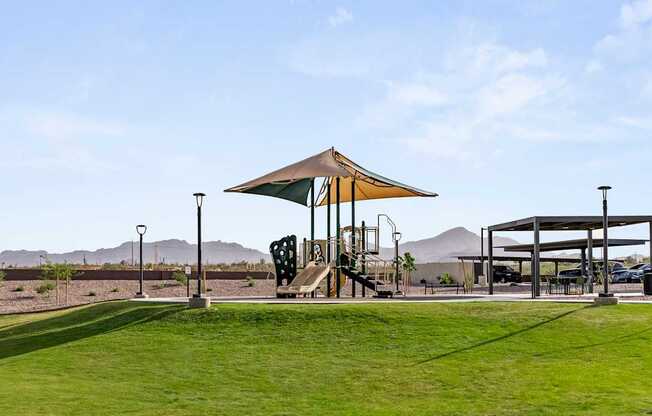 A playground with a slide and a canopy is in the foreground.