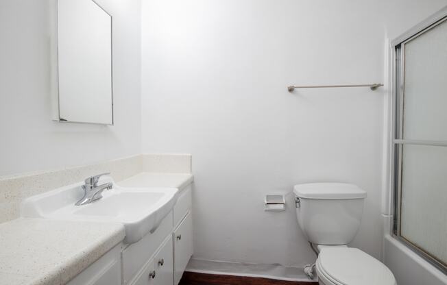 a bathroom with a sink toilet and a shower