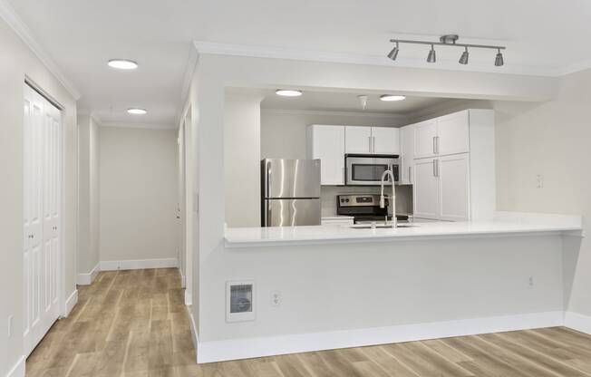 a kitchen with white cabinetry and a white counter top