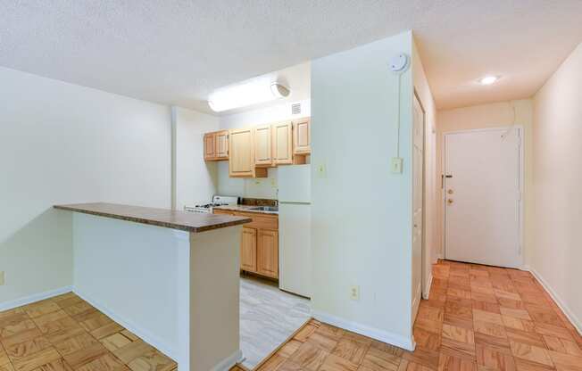 kitchen with wood cabinetry, gas range and breakfast bar at twin oaks apartments columbia heights washington dc