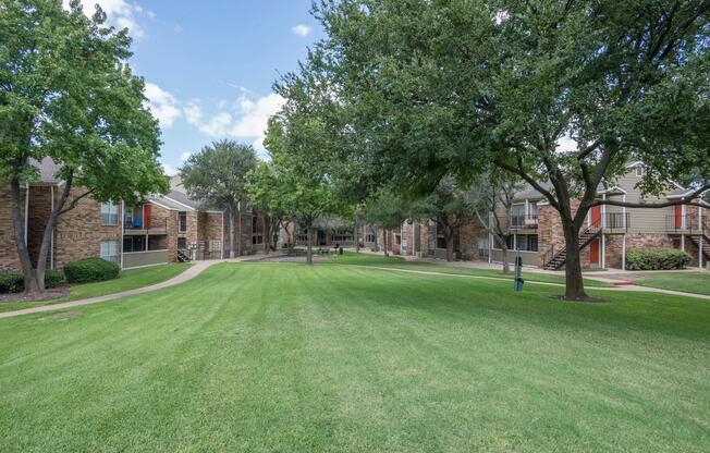 a green field between community buildings