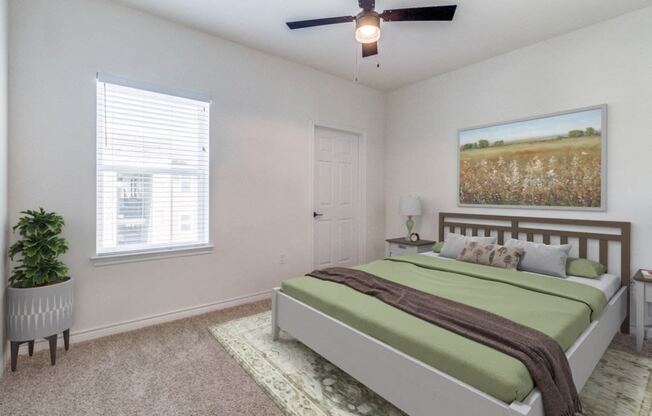 a bedroom with a bed and a ceiling fan