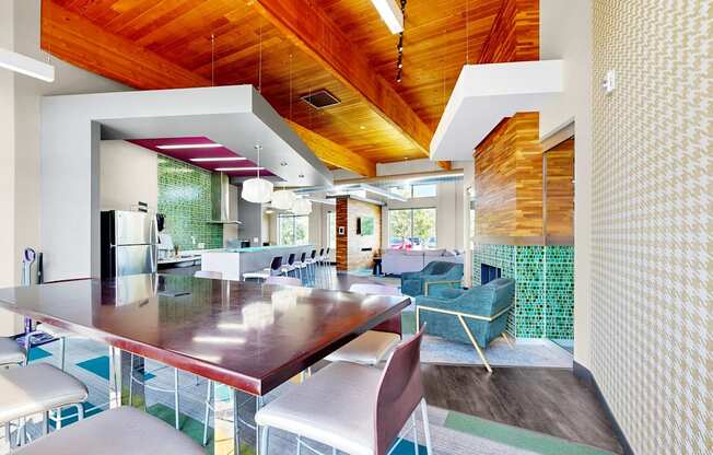 A modern dining room with a long table and chairs.