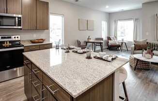 A kitchen with a large island and modern appliances.