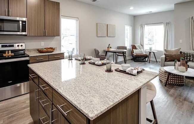 A kitchen with a large island and modern appliances.