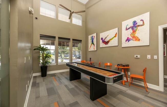 Clubhouse with fitness-themed wall art at Woodbridge Villas Apartments, Texas