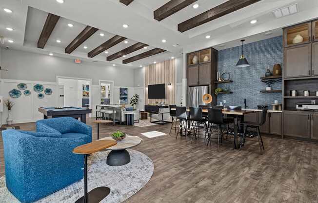 A modern open plan living and kitchen area with a blue sofa.