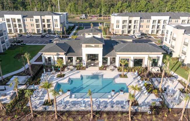 A large white building with a pool in front.