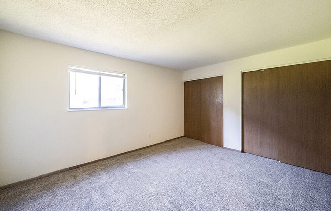 spacious primary bedroom with closets