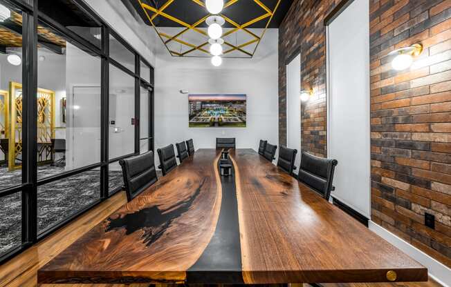 a conference room with a long wooden conference table and brick walls