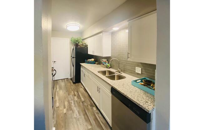 a kitchen with a sink and a mirror