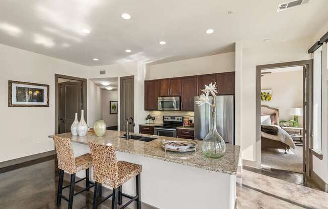 A kitchen with a bar area and a dining table.